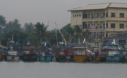 Fishing pier with Sula's mast behind the fishing boats
